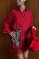 Thumbnail for Cherry Leopard Mini Maeva Skirt with burgundy lace trim, styled with a red shirt and a matching bow-detail bag.