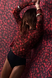Cherry Mesh Long Sleeve Top in sheer red fabric, styled against a matching cherry print backdrop.