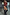Thumbnail for Sheer red Cherry Mesh Long Sleeve Top featuring a vibrant cherry print, styled with tall black boots in a mirror selfie.