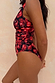 Black Cherry Plunge Suit with an all-over red cherry print and gathered waist detailing, shown from a side profile.
