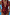 Thumbnail for Black Cherry Plunge Suit with an all-over cherry print, plunging neckline and gathered waist, poolside.