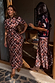 Two models wearing the Check Floral Lottie Skirt in chocolate brown, highlighting the inclusive sizing and midi length.