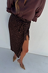 Chocolate Sequin Jaspre wrap skirt with a side slit, styled with a brown shirt and tan heels.