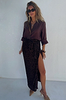 The iconic Chocolate Sequin Jaspre Skirt in a wrap design, paired with a matching brown shirt.