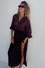 Thumbnail for Model wearing the iconic Chocolate Sequin Jaspre Skirt with a high slit and matching brown blouse.
