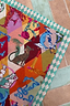 Circus Bandana featuring a teal checkered border and vibrant multicoloured motifs like leopards, lobsters, and moons.