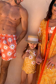 Girl's Yellow Sun Swimsuit with frill trim and sun print, worn with a straw hat for a coordinated family energy look.