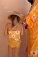 Girl's Yellow Sun Swimsuit back view with sun print, crossover straps and frill detailing, paired with a matching robe.