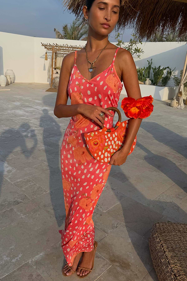 Coral Fawn Beaded Bag with poppy motifs, glass bead embroidery and a wooden handle, styled with a matching dress.