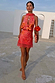 Coral Fawn Poppy Mini Maeva Skirt featuring a floral print and pink lace hem, styled as a co-ord on a stone patio.