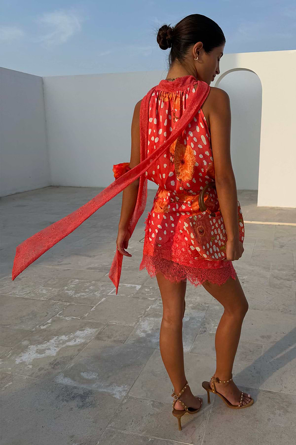 Coral Fawn Poppy Mini Maeva Skirt in pink with a deer print and lace hem, styled as a co-ord.