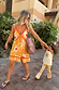 Girl's Yellow Sun Cotton Set featuring a sequin soleil vest and flared trousers, worn by a child outdoors.
