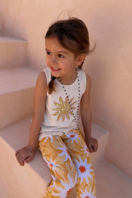 NFD Kids Yellow Sun Cotton Set with a cream sequin sun vest and matching printed trousers on a young girl.