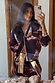 Navy Cowboy Boots Cardigan with red cowgirl motifs and pink trims, styled with a matching skirt in a mirror selfie.