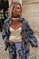 Cowgirl Ro Knitted Tank in cream and tan with red trim, layered with a blue paisley denim jacket and matching trousers.