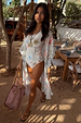 Cream Palma Kimono featuring a colorful Sol De Palma print and frill hem, styled over a matching swimsuit.