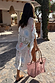 Cream Palma Kimono featuring the Sol De Palma print and frill hem, styled as a vacation cover-up with a pink tote.