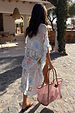 Cream Palma Kimono featuring the Sol De Palma print and frill hem, styled as a vacation cover-up with a pink tote.