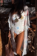 Cream Palma Kimono in the Sol De Palma print with hand-painted motifs and a frilled hem, styled over a swimsuit.