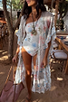 Cream Palma one-shoulder swimsuit with palm and sun motifs and crochet trim, styled with a matching printed kimono.