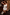 Thumbnail for Cream Palma One Shoulder Swimsuit with hand-painted palm motifs, script print and orange crochet trim on a model.