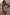 Thumbnail for Cream Palma One Shoulder Swimsuit with hand-painted palm motifs and crochet trim on a model for inclusive sizing.