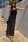 Black Crochet Alicia Dress with silver sequins and a gathered chiffon skirt, styled for vacation wear.
