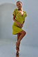 Green Shell Mini Elodie Dress with a crochet knit bodice and lightweight satin skirt on a model.