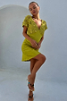 Green Shell Mini Elodie Dress with a crochet knit bodice and lightweight satin skirt on a model.