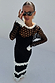 Black Mono Crochet Chloe Dress with white frilled trims and a wide fishnet knit structure on a model.