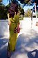 Green Shell Crochet Tilly Dress with shell embellishments and a satin skirt, shown from the back while on vacation.