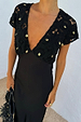 Black Crochet Shell Elodie Dress with gold shell charms on the crochet bodice and a black satin skirt.