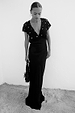 Black Crochet Shell Elodie Dress with a shell-embellished crochet bodice and satin skirt in a seaside setting.