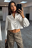 Thumbnail for White Cropped Cotton Miley Shirt featuring tortoise buttons and blouson sleeves, paired with leopard print trousers.