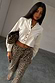Thumbnail for White Cropped Cotton Miley Shirt with tortoise buttons and blouson sleeves, styled with leopard print trousers.