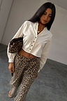 White Cropped Cotton Miley Shirt with tortoise buttons and blouson sleeves, styled with leopard print trousers.