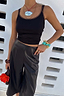 Thumbnail for Black Vegan Leather Culottes featuring a wide leg and front crease, styled with turquoise accessories.