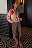 Thumbnail for Pink Dallas Cardigan with abstract cowboy motifs and striped trim, styled with leopard print trousers.