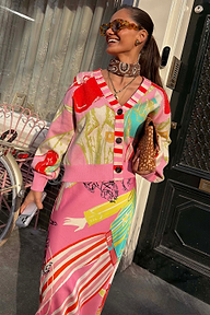 Pink Dallas Cardigan featuring abstract cowboy motifs and a striped button stand, styled with a matching patterned skirt.