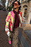 Pink Dallas Reversible Jacket with quilted patchwork, leopard trim and lace cuffs on a city street.