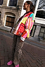 Reversible Pink Dallas Quilted Jacket featuring vibrant patchwork prints and lace cuffs, styled for a bold London look.