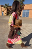 Pink Dallas Dorris Skirt featuring an in-house abstract cowboy print, styled with a leopard clutch and brown suede boots.