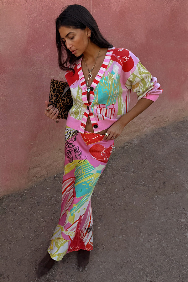Pink Dallas Dorris Skirt featuring an abstract cowboy print, styled with a matching cardigan and leopard clutch.