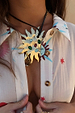 Deloris Sun Necklace with a gold sun pendant and colourful semi-precious stones, styled on a black leather cord.