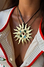 Deloris Sun Necklace in textured brass with colourful semi-precious stones and a black leather cord.