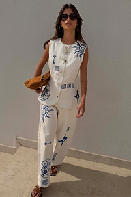 Dolce Vita ecru denim waistcoat featuring blue sun embroidery, styled with matching co-ord barrel leg jeans.
