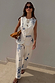 Dolce Vita ecru denim co-ord with blue Greek-inspired motifs, featuring barrel leg jeans and matching waistcoat.