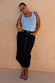 Dark blue Denim Pencil Skirt with contrast stitching, styled with a light blue tank top on a curve model.