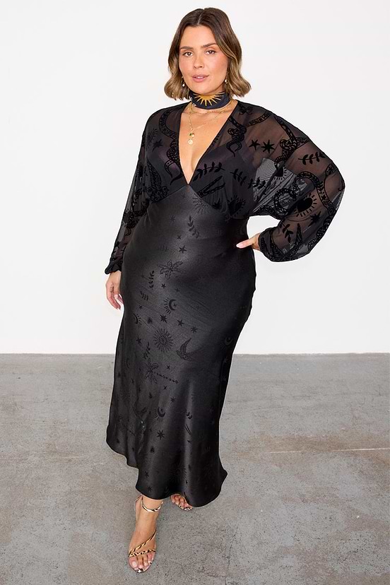 Black Swallow Romance Emma Dress in sheer devore velvet and satin, featuring a celestial swallow print, on a curve model.