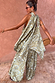 Olive green diamond print halter top with a draped back and asymmetric hem, styled with matching co-ord trousers.